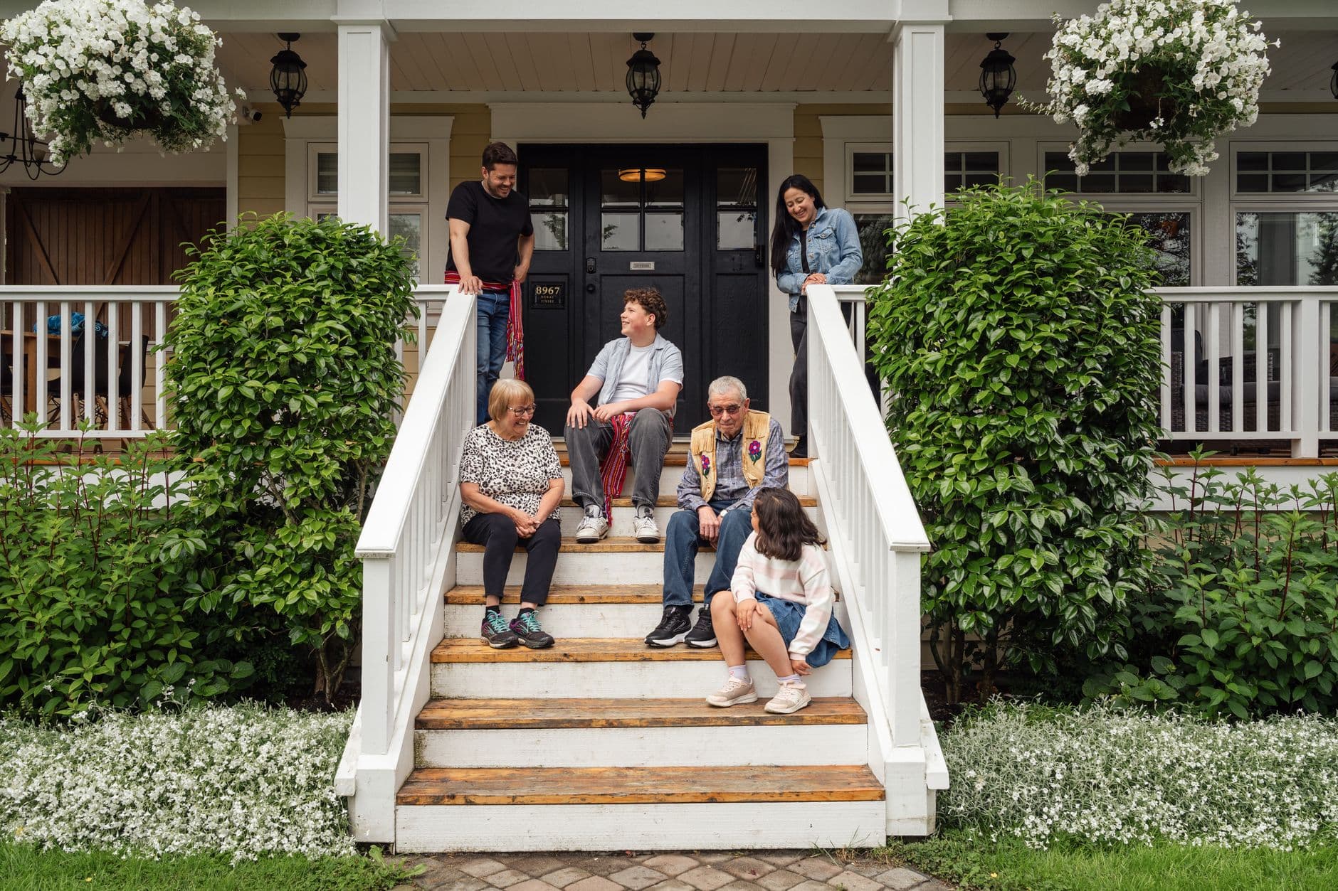 A diverse family enjoying quality time together on a porch, showcasing warmth and community.